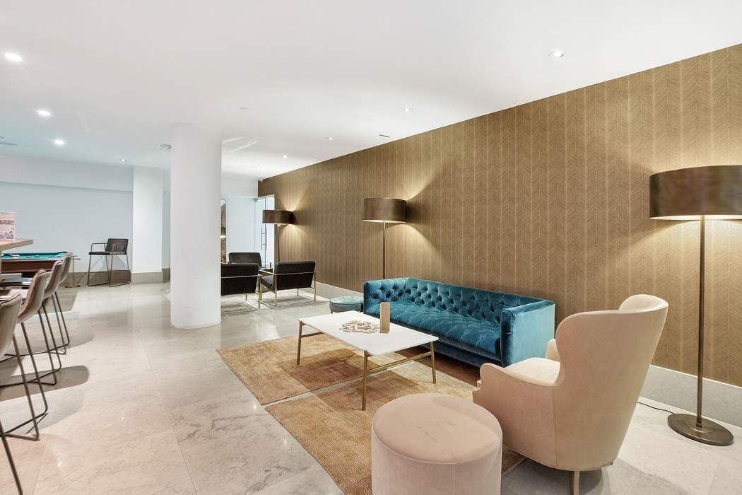 429 Kent Avenue, Unit 503 Brooklyn, NY 11249 - Photo 11 of 14 a living room with furniture and a table