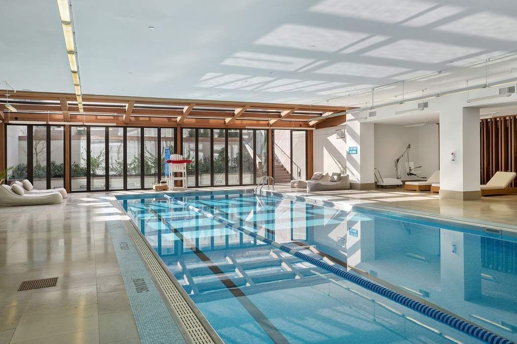 429 Kent Avenue, Unit 503 Brooklyn, NY 11249 - Photo 13 of 14 a large white kitchen with a large window