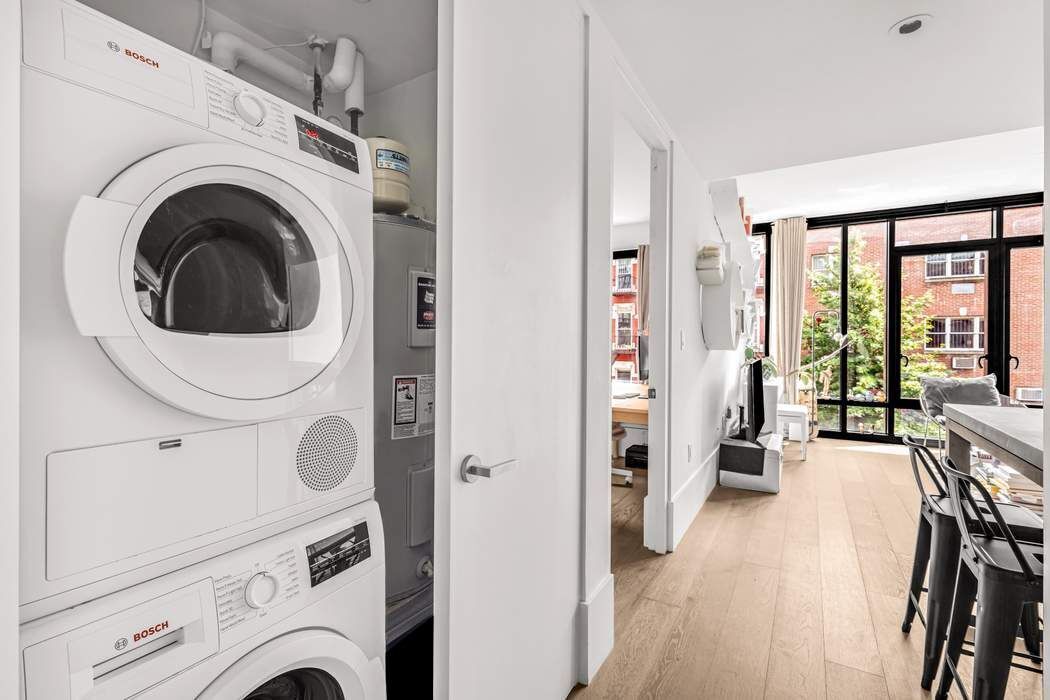 429 Kent Avenue, Unit 503 Brooklyn, NY 11249 - Photo 5 of 14 a view of a hallway with washer and dryer