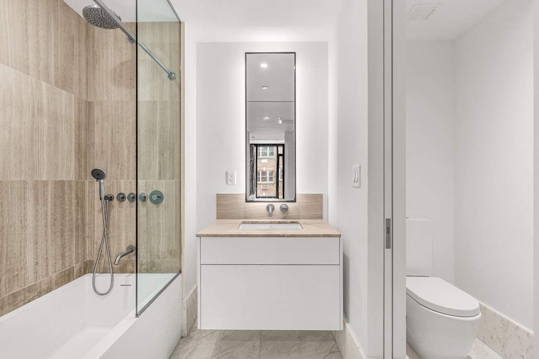 429 Kent Avenue, Unit 503 Brooklyn, NY 11249 - Photo 7 of 14 a bathroom with a sink a toilet and shower