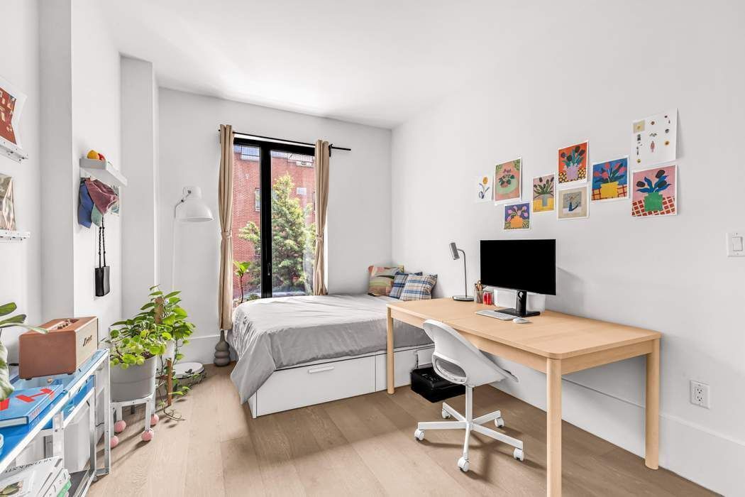 429 Kent Avenue, Unit 503 Brooklyn, NY 11249 - Photo 9 of 14 a workspace with furniture and window