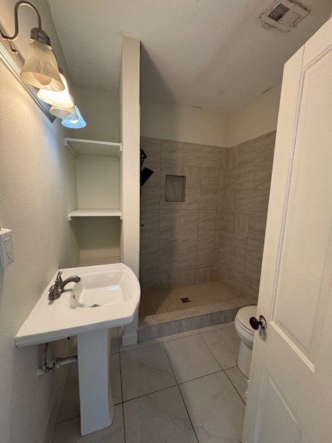 1616 North Travis Street Liberty, TX 77575 - Photo 21 of 23 a bathroom with a sink a toilet and shower