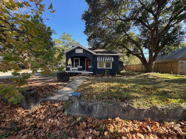 1616 North Travis Street Liberty, TX 77575 - Photo 3 of 23 a front view of a house with a yard covered with green space