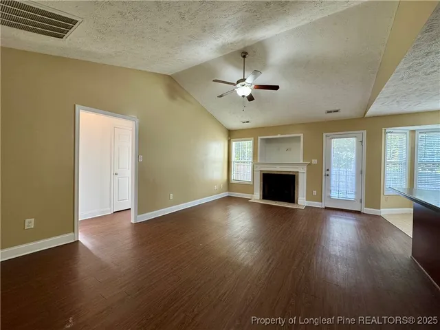 a view of kitchen with cabinets appliances and wooden floor