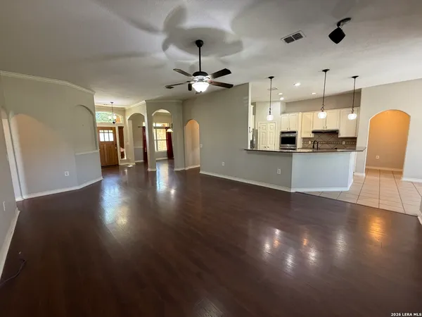 a view of a kitchen and dining room with wooden floor