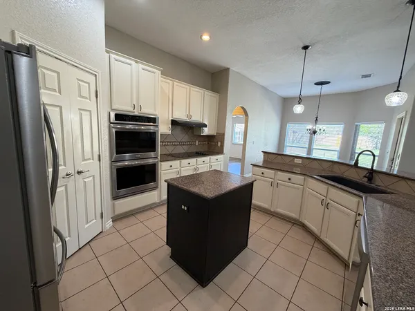 a kitchen with stainless steel appliances granite countertop a stove a refrigerator and a refrigerator