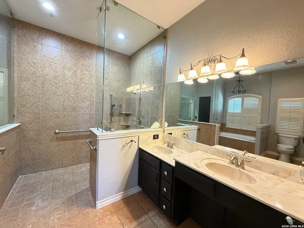 a bathroom with a double vanity sink and a mirror