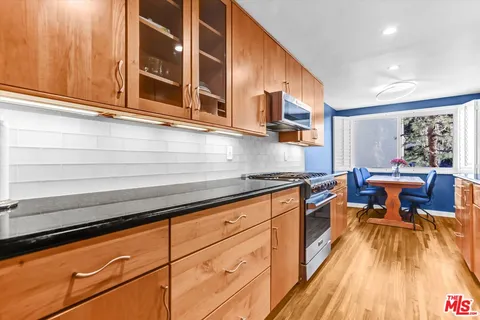 a kitchen with stainless steel appliances granite countertop a sink and cabinets