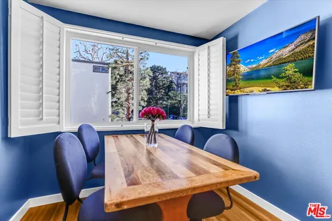 a view of a workspace with furniture and window