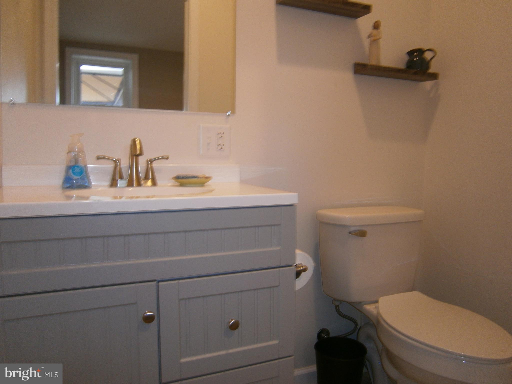 386 Monroeville Road Monroeville, NJ 08343 - Photo 22 of 23 a bathroom with a sink a toilet and a mirror