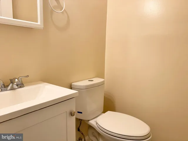 a white toilet sitting next to a bathroom sink