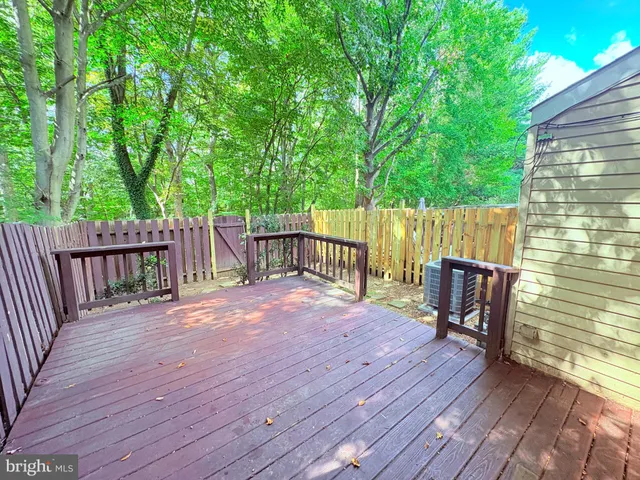 a view of a deck with wooden floor and fence