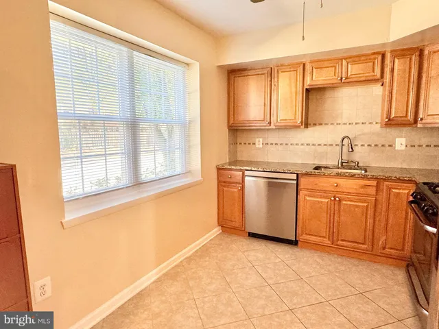 a kitchen with a stove a sink and a refrigerator