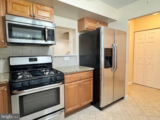 a kitchen with a stove microwave and refrigerator