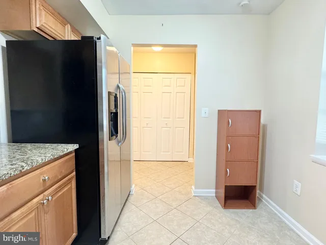 a view of walk in closet and bedroom