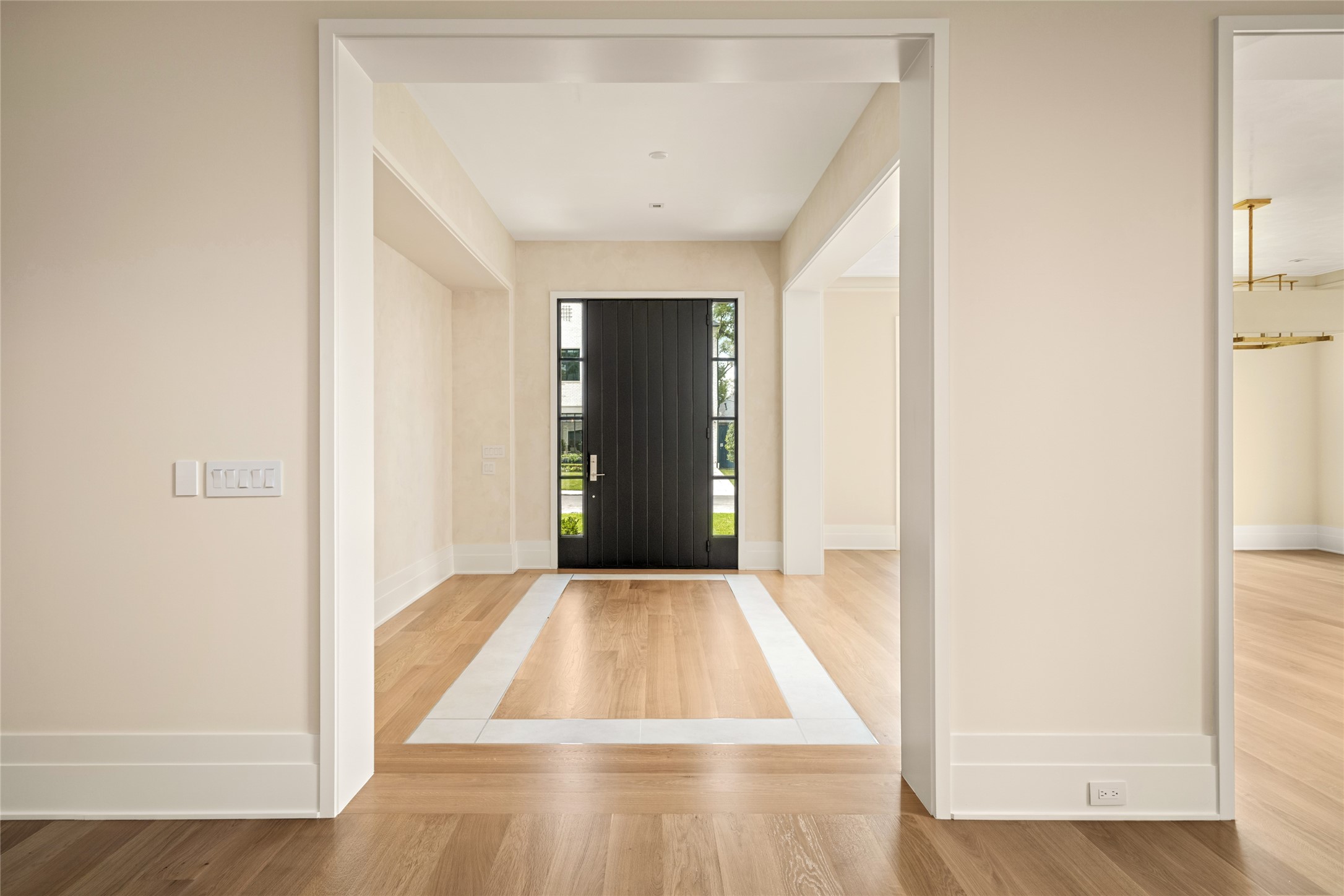 4006 Overbrook Lane Houston, TX 77027 - Photo 4 of 50 Refined foyer framed by French oak hardwoods with an Italian porcelain inlay detail, adding subtle dimension against smooth plastered walls
