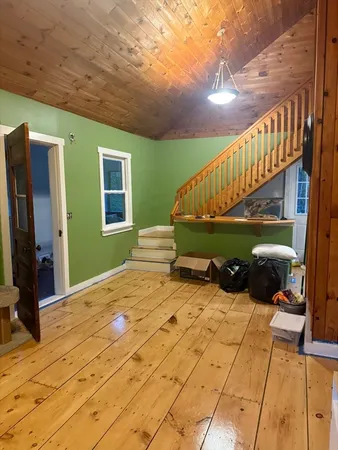 a view of balcony with wooden floor and a potted plant