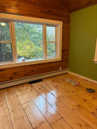 a view of a room with wooden floor and iron stairs