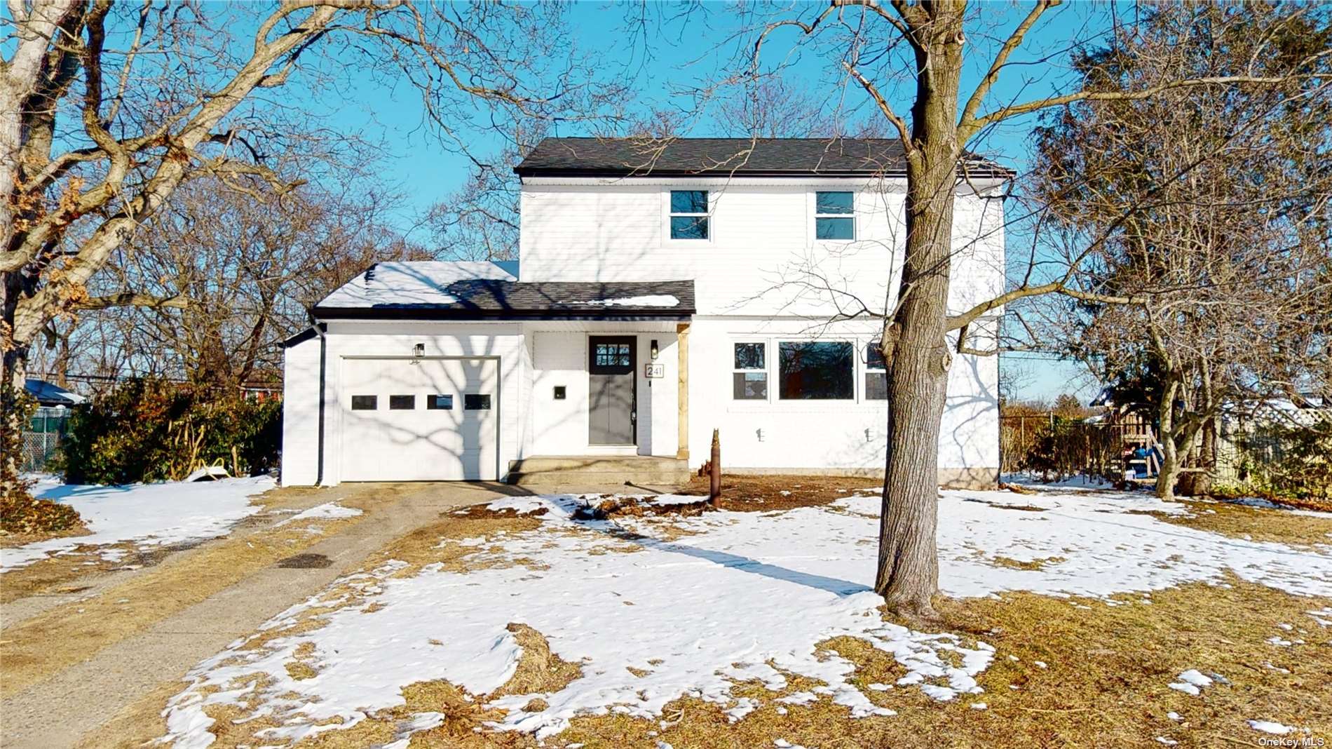 241 Tree Road Centereach, NY 11720 - Photo 1 of 1 a view of a house with snow on the road