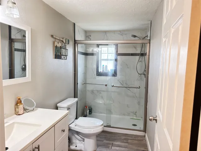 a bathroom with a sink toilet and shower