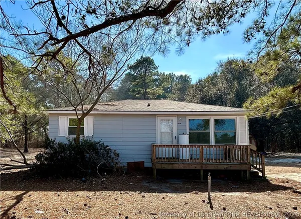 a view of a house with a deck and a garden