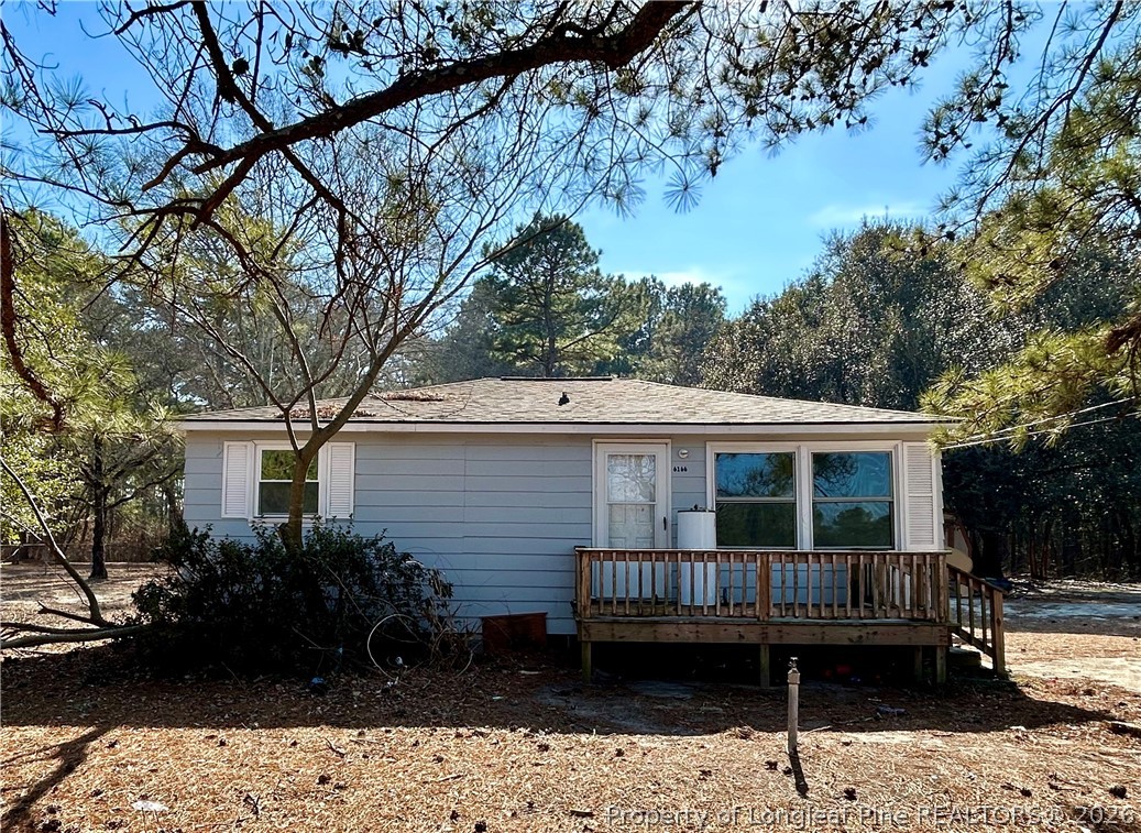 a view of a house with a deck and a garden