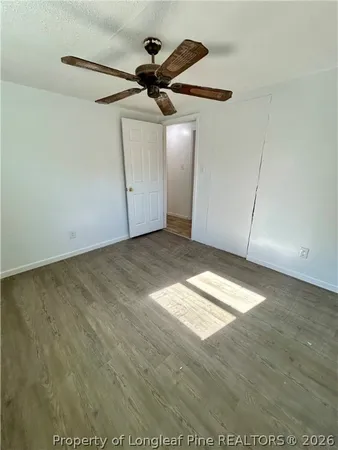 an empty room with wooden floor