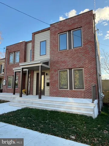 a view of brick building with a yard
