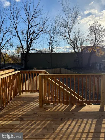 a view of street with wooden fence