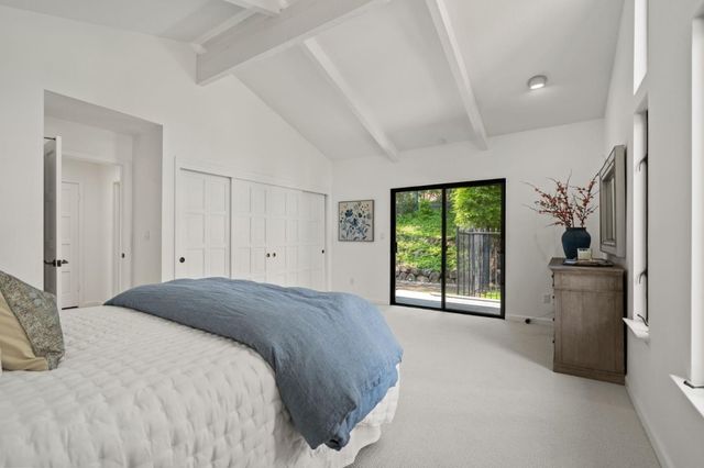 a bedroom with a bed and window