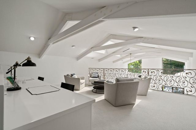 a living room with furniture and a clock