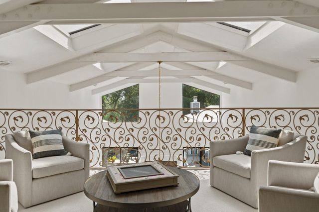 a view of workspace with a table and a clock