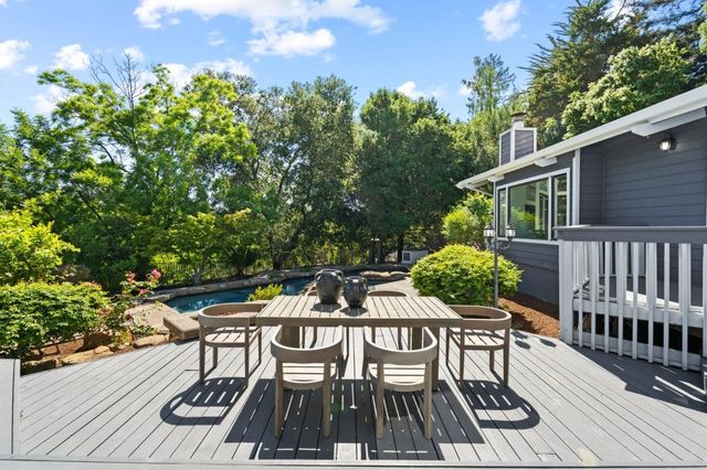 a view of a house with swimming pool and a chairs
