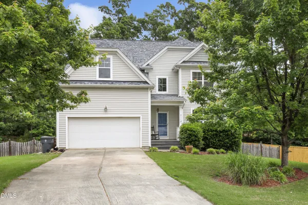 a front view of a house with a yard and a garage