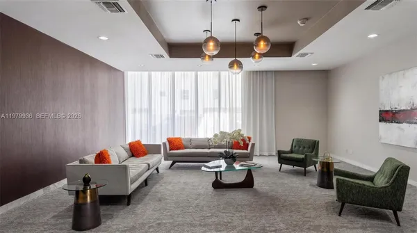 a living room with furniture and a chandelier