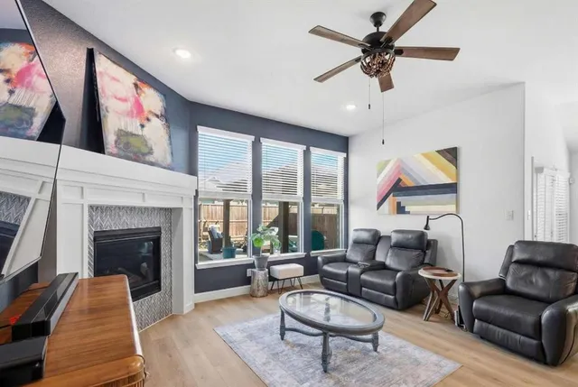 a living room with furniture kitchen view and a chandelier