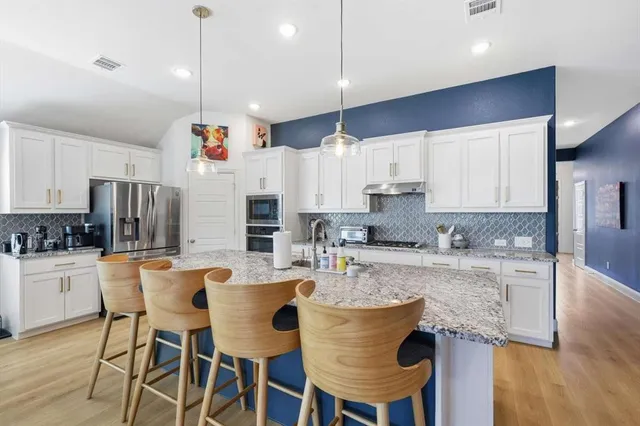 a view of kitchen island kitchen island granite countertop living room and couch