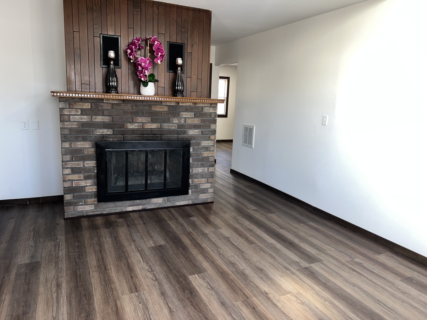 101 Louis Road Joliet, IL 60433 - Photo 7 of 17 a living room with wooden floor and a fireplace