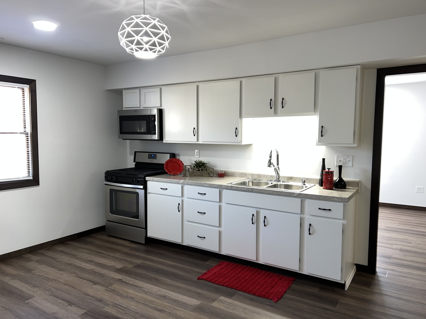 101 Louis Road Joliet, IL 60433 - Photo 8 of 17 a kitchen with granite countertop a sink cabinets and wooden floor