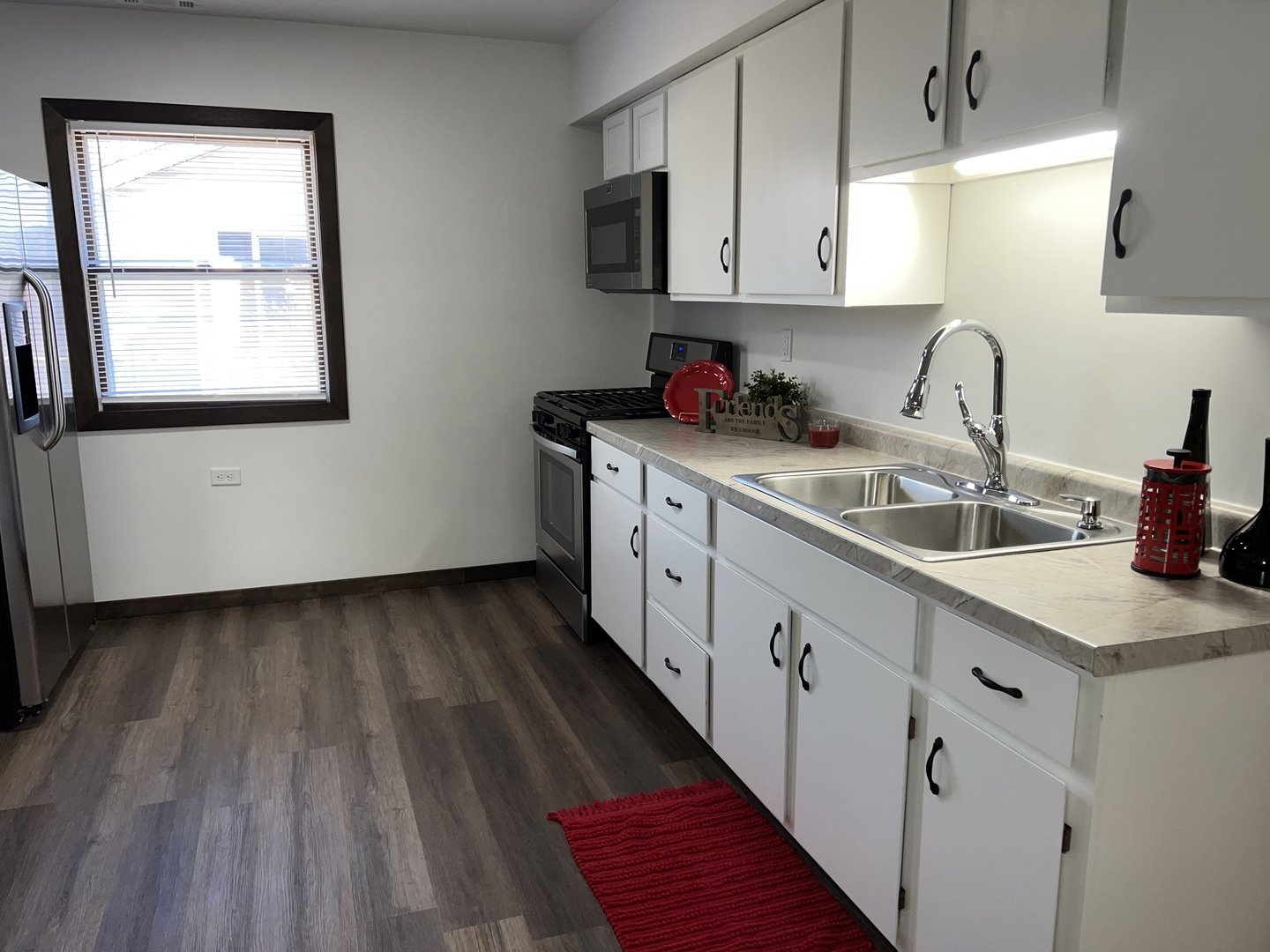 101 Louis Road Joliet, IL 60433 - Photo 9 of 17 a kitchen with granite countertop white cabinets and white appliances