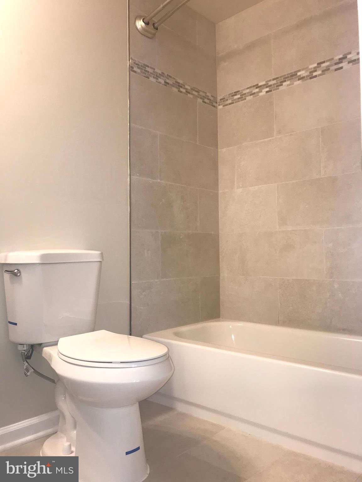 8657 Ritchboro Road District Heights, MD 20747 - Photo 17 of 23 a bathroom with a toilet and a shower