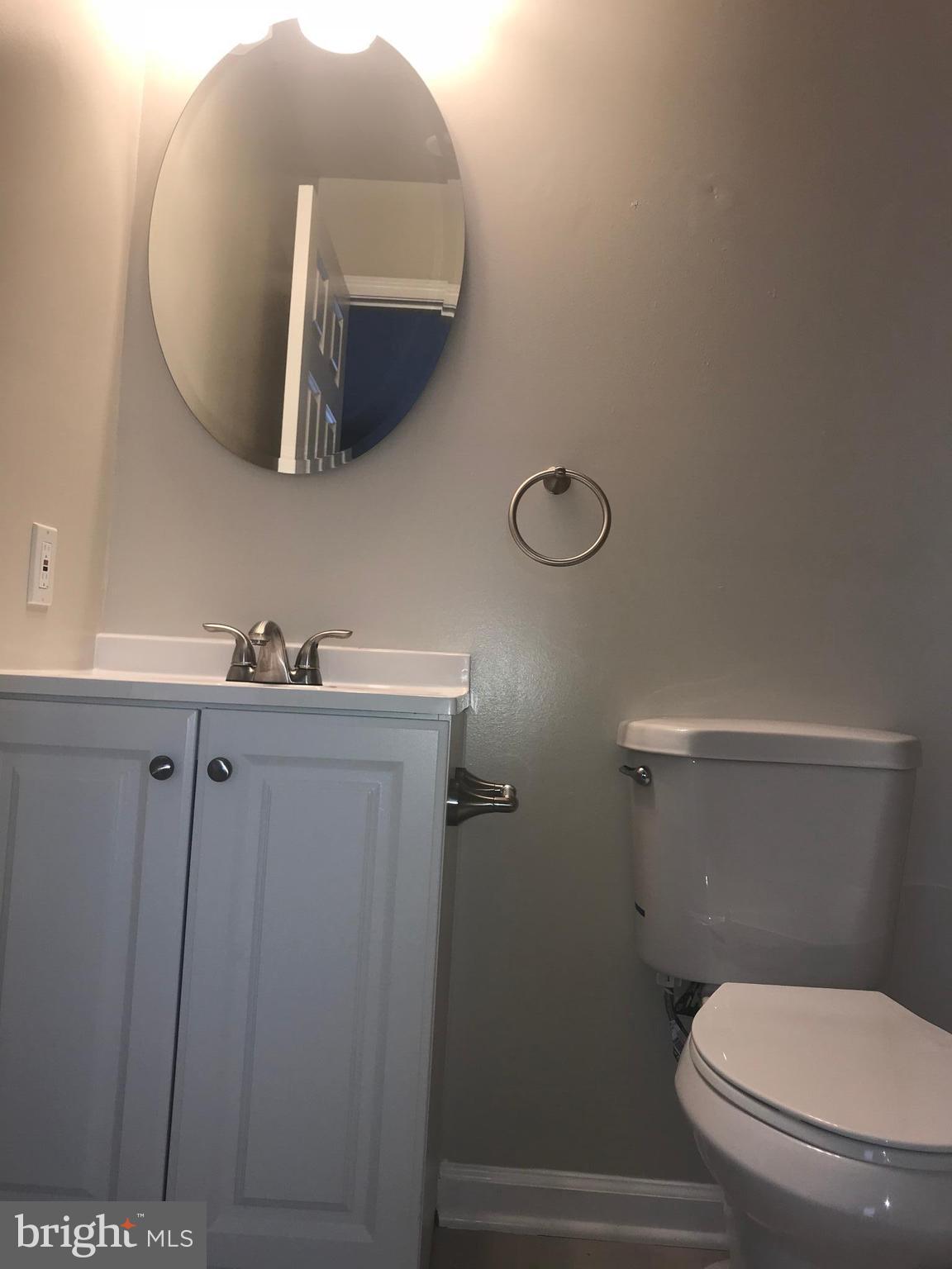 8657 Ritchboro Road District Heights, MD 20747 - Photo 18 of 23 a bathroom with a toilet and a mirror
