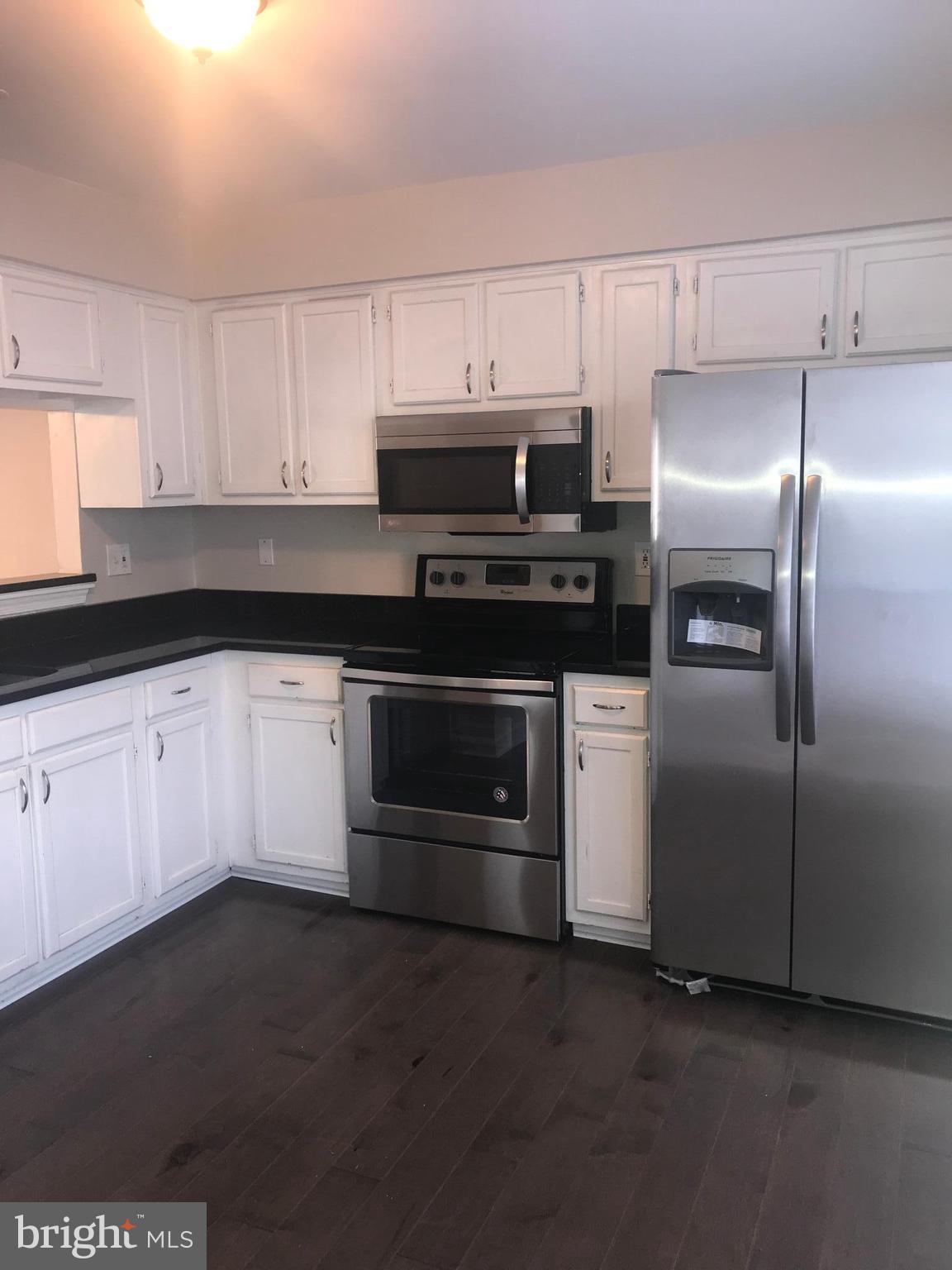 8657 Ritchboro Road District Heights, MD 20747 - Photo 4 of 23 a kitchen with granite countertop white cabinets and stainless steel appliances