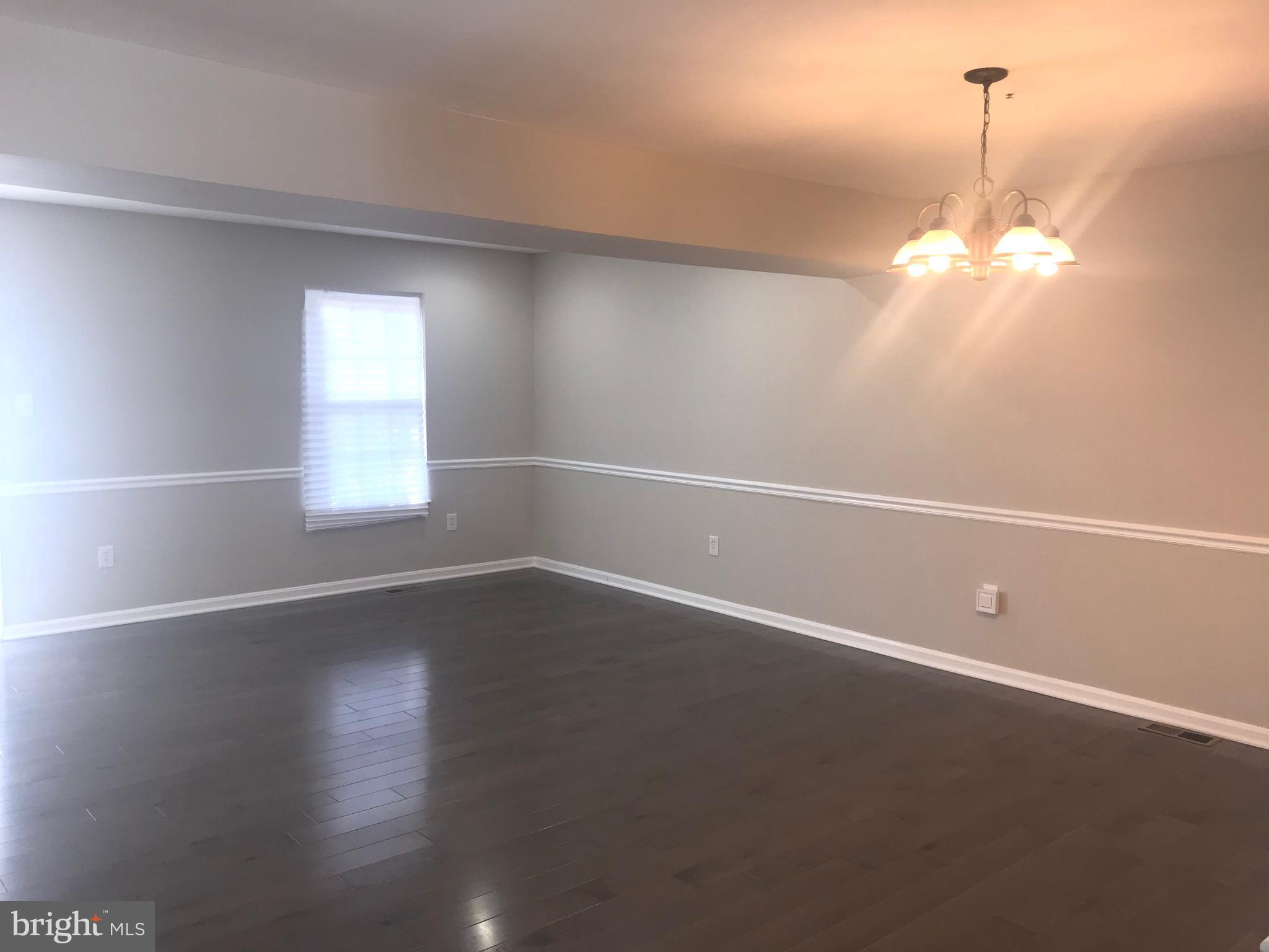 8657 Ritchboro Road District Heights, MD 20747 - Photo 7 of 23 a view of a room with wooden floor and window