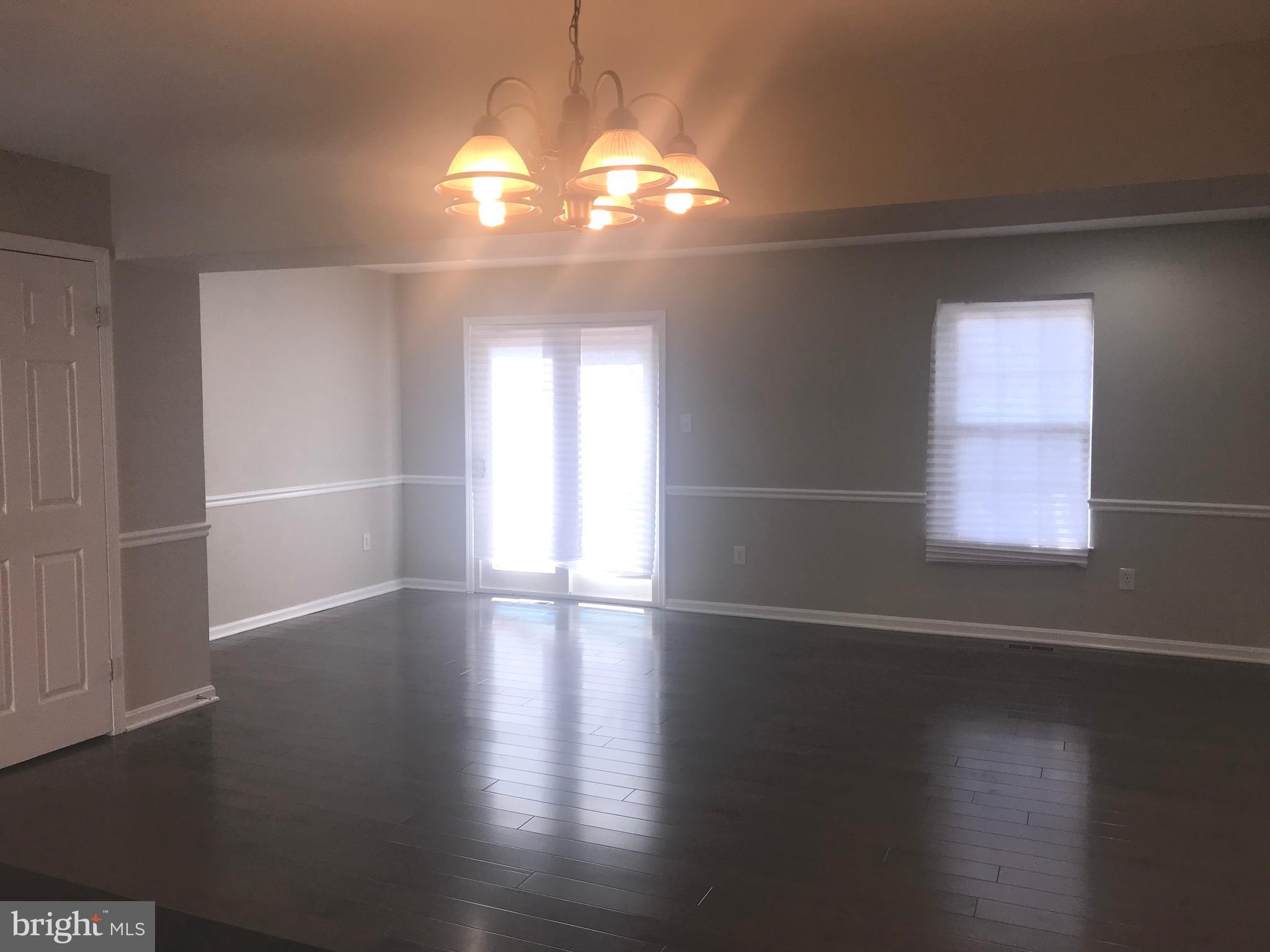 8657 Ritchboro Road District Heights, MD 20747 - Photo 8 of 23 an empty room with wooden floor and windows