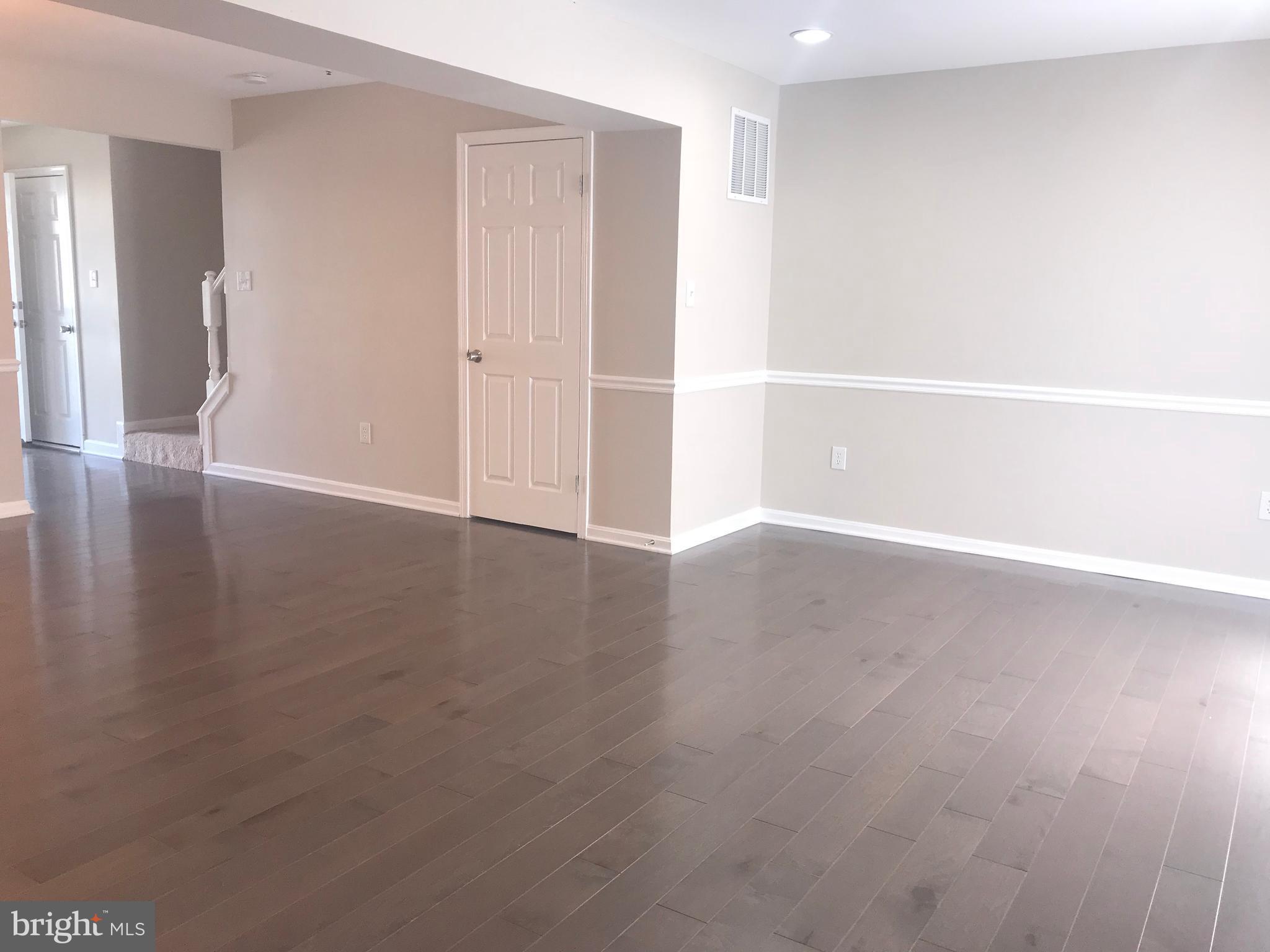 8657 Ritchboro Road District Heights, MD 20747 - Photo 10 of 23 a view of an empty room with wooden floor