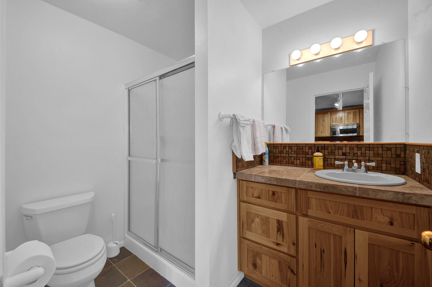 67100 Fryrear Road Bend, OR 97703 - Photo 33 of 38 a bathroom with a toilet a sink a vanity and mirror