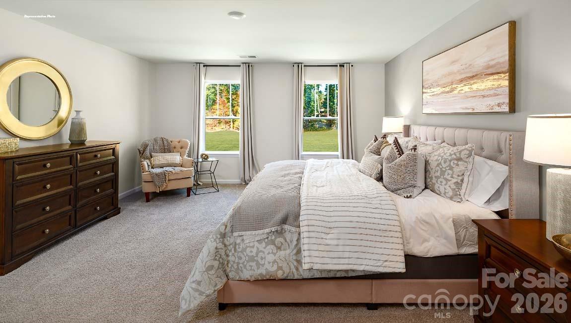 602 Dazzle Loop Newton, NC 28658 - Photo 14 of 29 a bedroom with a bed a dresser next to a window
