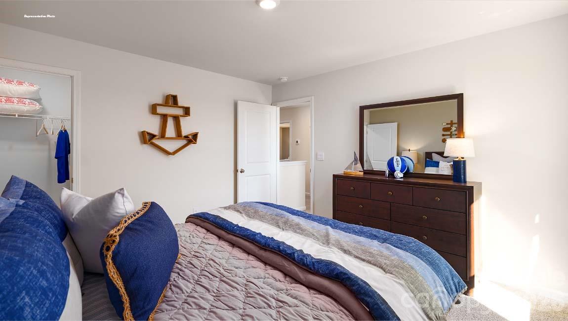602 Dazzle Loop Newton, NC 28658 - Photo 22 of 29 a bedroom with a bed and a mirror on dresser