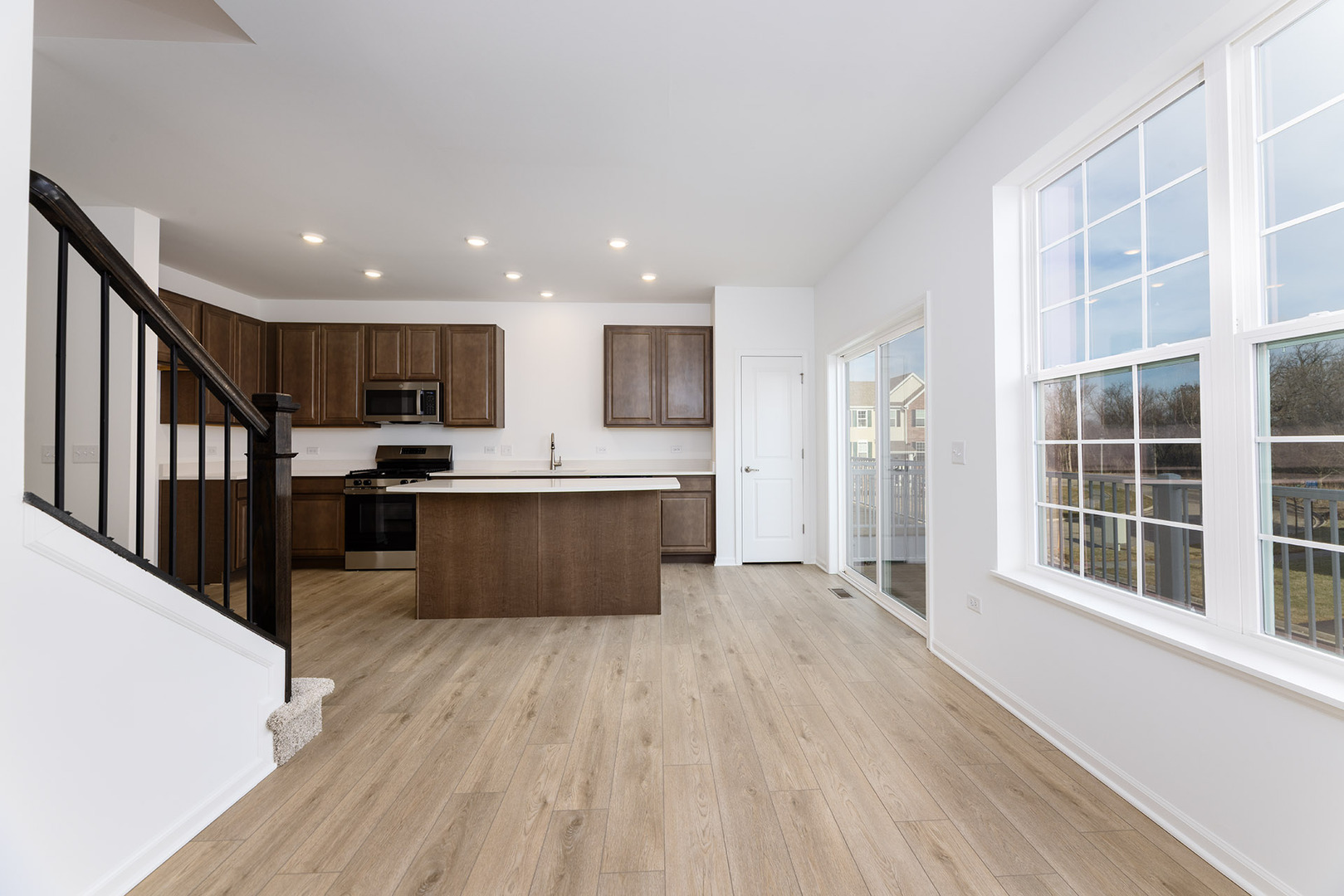 1703 Neubauer Circle Lindenhurst, IL 60046 - Photo 16 of 37 a large kitchen with stainless steel appliances kitchen island granite countertop a large counter top and a stove top oven